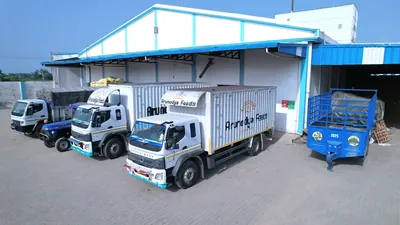 Branded Arunodya Feeds trucks under the loading canopy