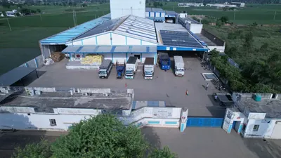 The Arunodya Feeds plant from the air, with branded trucks loading under the dispatch canopy